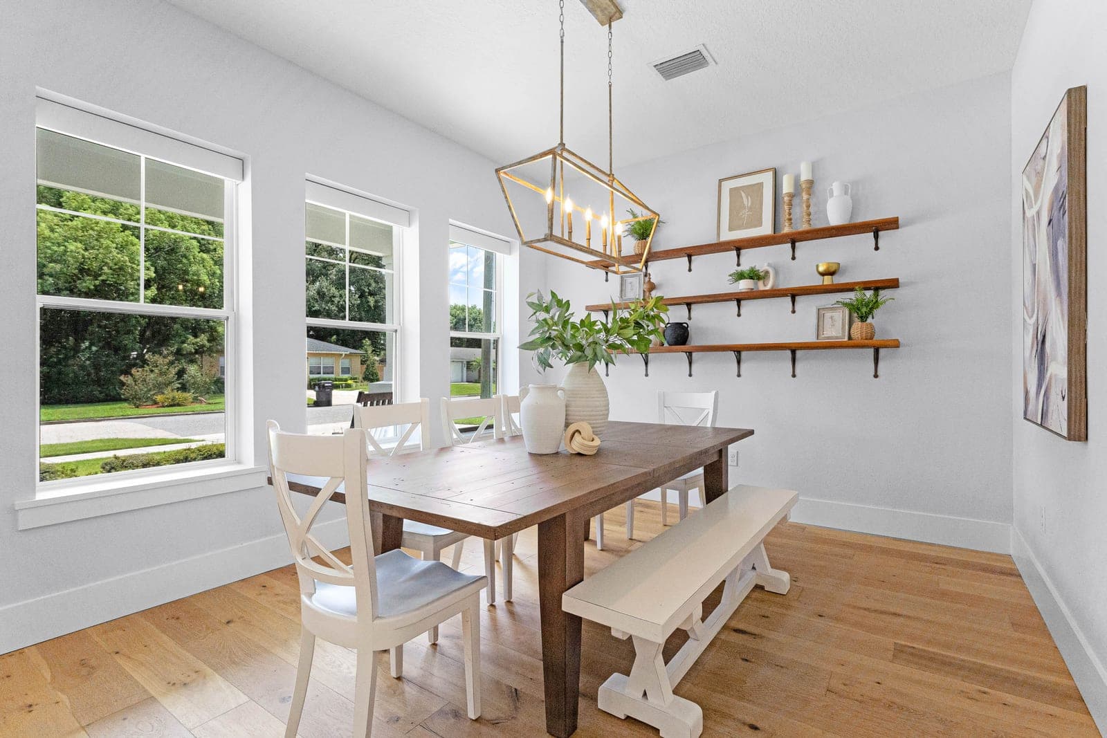 Dining room in a Central Florida home, warm, lived-in, lit by big windows